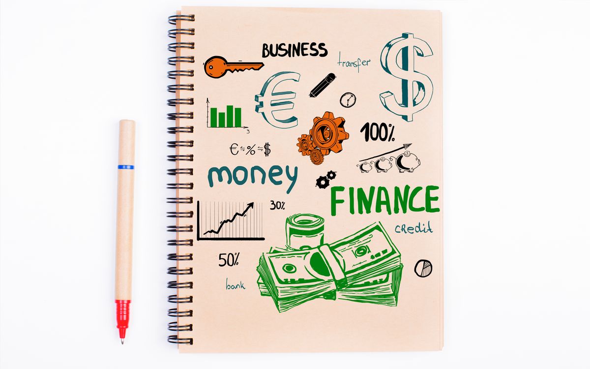 Notebook pages with revenue figures, project notes and timeline annotations